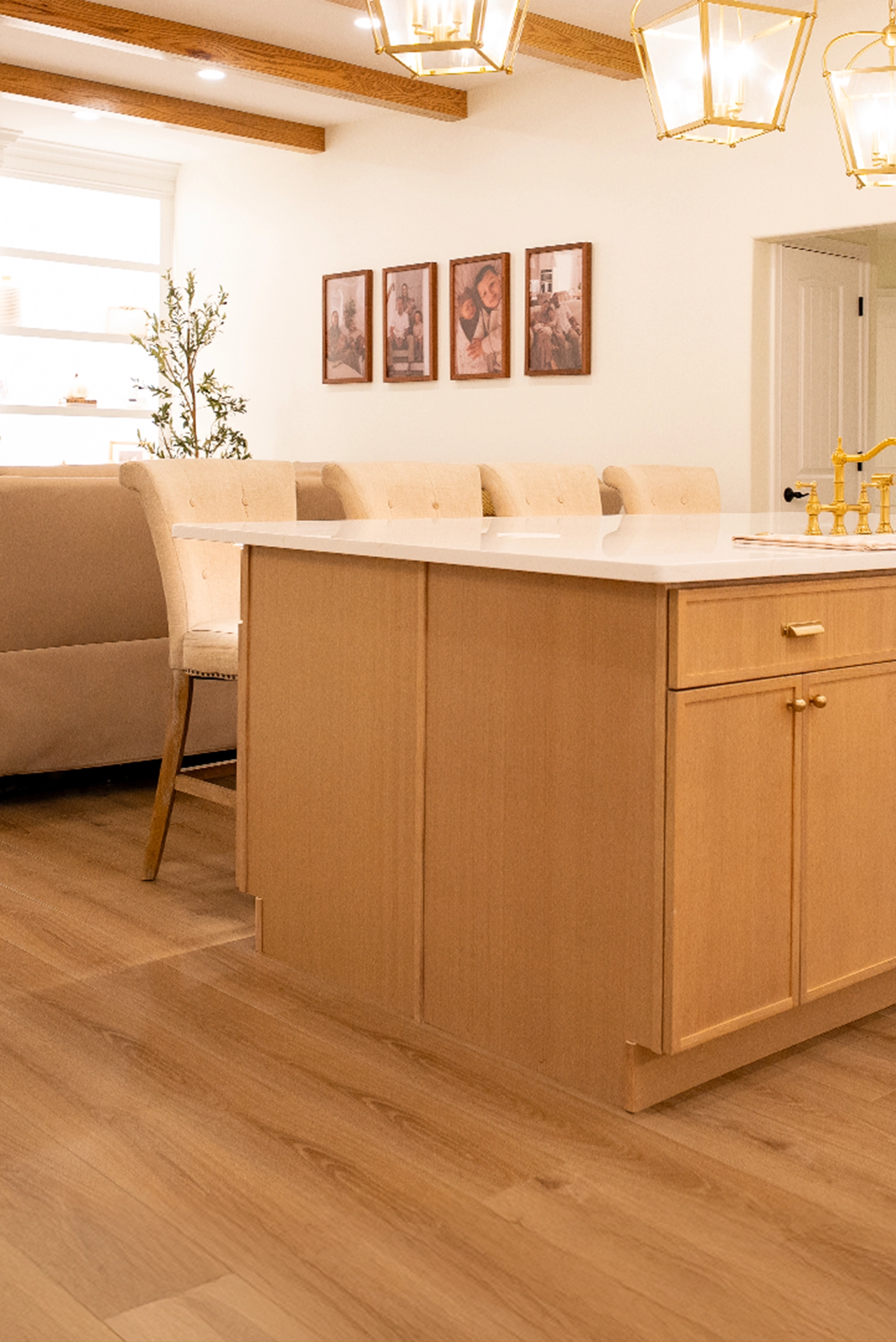Modern kitchen island design featuring light oak cabinetry, white quartz countertops, and brass hardware.